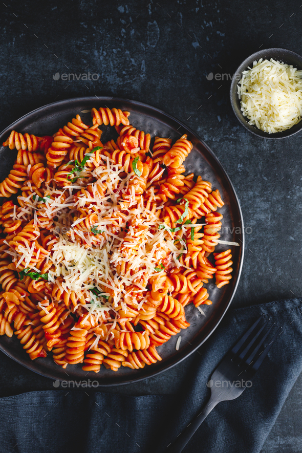 Top view of fusilli pasta with tomato sauce and parmesan cheese on a black  background Stock Photo by Edalin