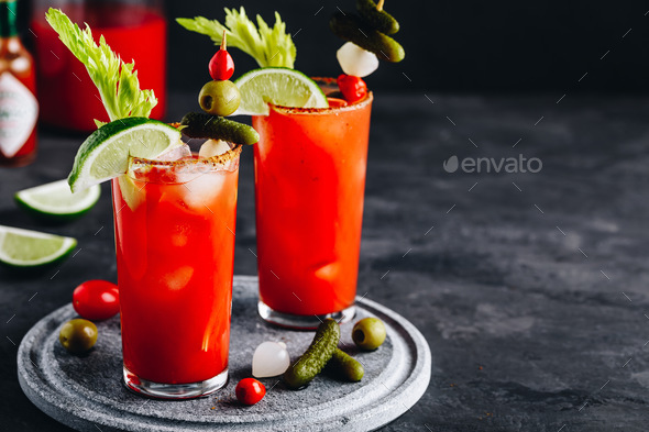 omato Bloody Mary ice cold drink with fresh celery, pickles and lime - Stock Photo - Images