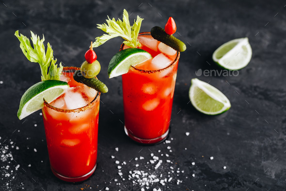 Bloody Mary Cocktail in glasses with garnishes. - Stock Photo - Images