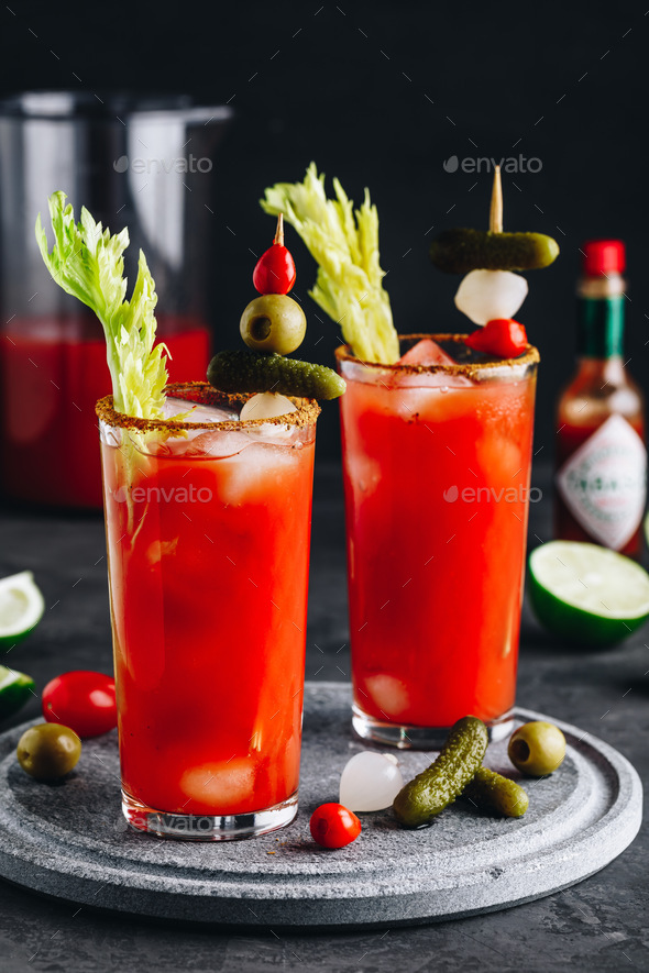 Bloody Mary Cocktail in glasses with garnishes. - Stock Photo - Images