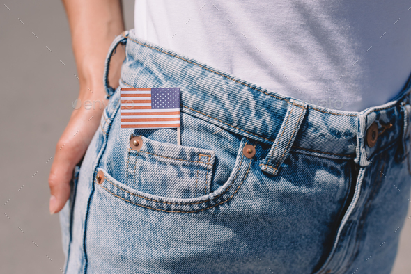 Partial View of Woman in Jeans With American Flagpole in Pocke