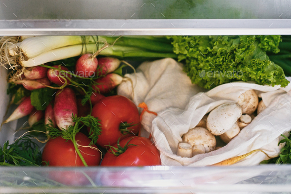 Zero waste grocery in fridge. Fresh vegetables in opened drawer in refrigerator - Stock Photo - Images