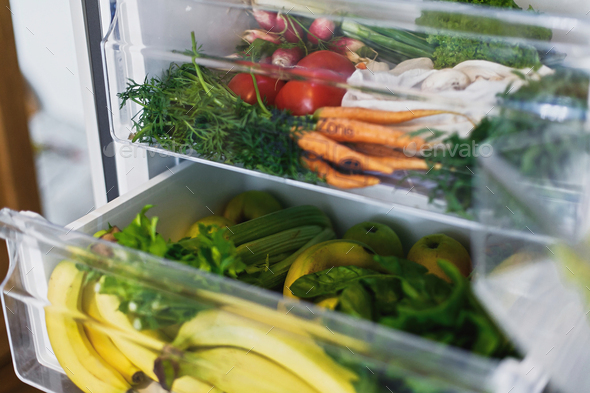 Zero waste grocery in fridge. Fresh vegetables in opened drawer in refrigerator.