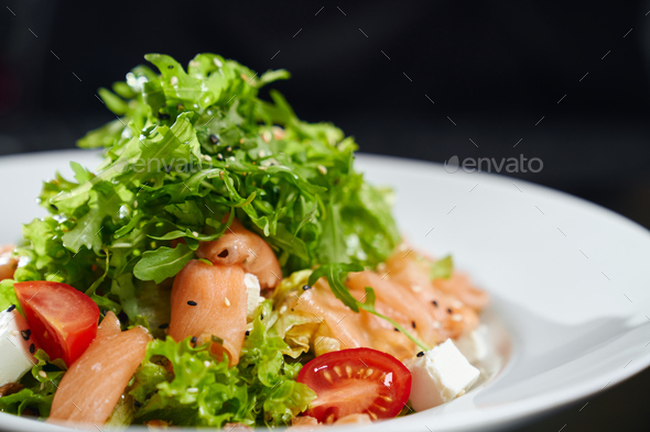 Fresh salad with salmon on plate - Stock Photo - Images