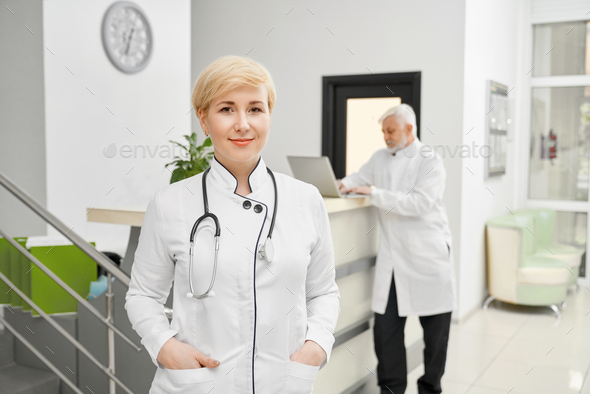 Female doctor keeping hands in pockets - Stock Photo - Images
