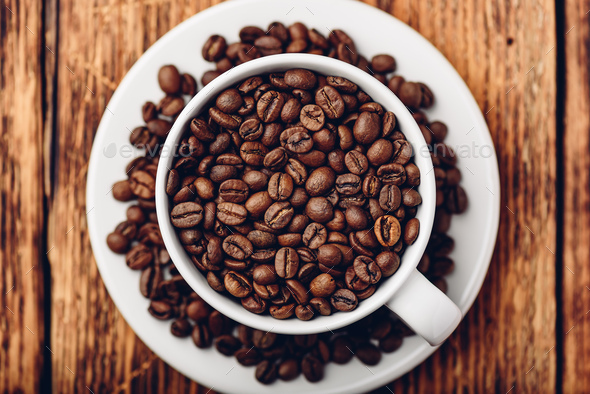 White cup full of roasted coffee beans - Stock Photo - Images