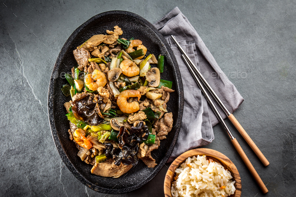 Chinese food. Te pam sao. Pan of fried different meat, shrimps shiitake mushroom - Stock Photo - Images