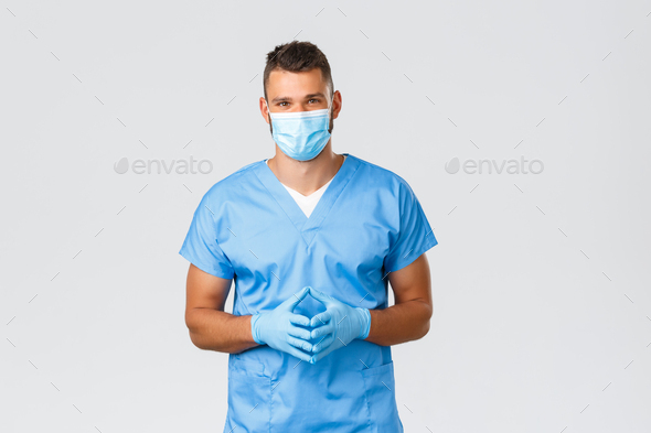 Healthcare workers, covid-19, coronavirus and preventing virus concept. Friendly handsome doctor - Stock Photo - Images