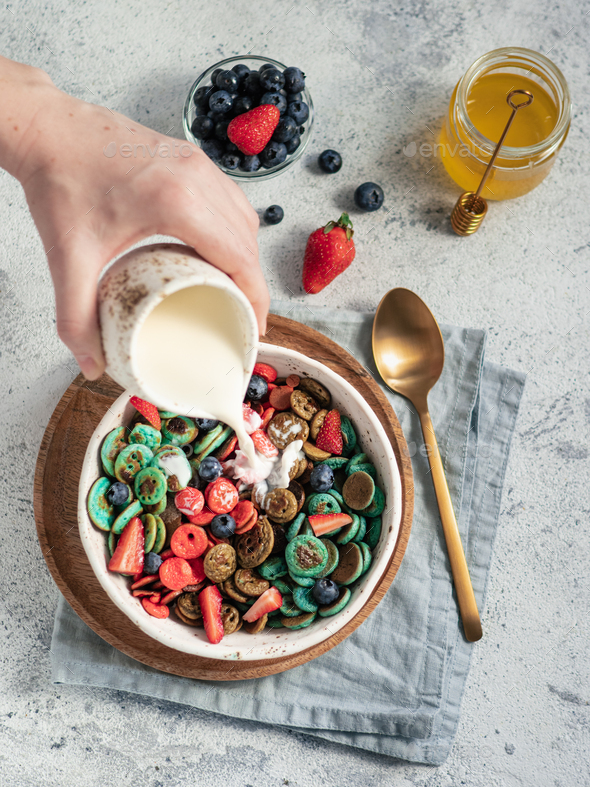 Milk poured on pancakes cereal, copy space - Stock Photo - Images