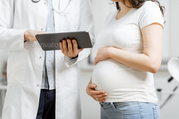 Doctor with pregnant woman during a medical consultation - Stock Photo - Images