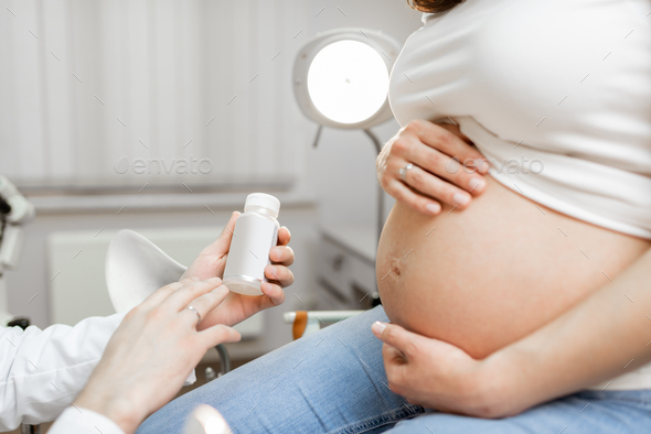 Holding medicine for a pregnant woman - Stock Photo - Images