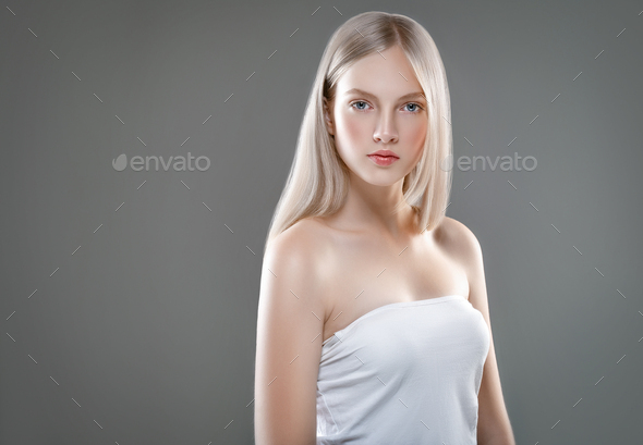 Beautiful Woman Face Portrait Beauty Skin Care Concept with long blonde hair over gray background - Stock Photo - Images