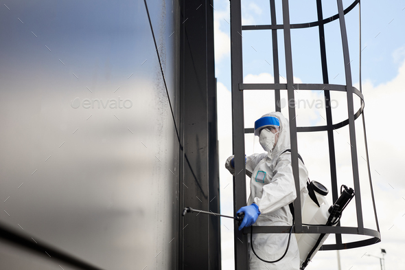 Worker Disinfecting Black Facade - Stock Photo - Images