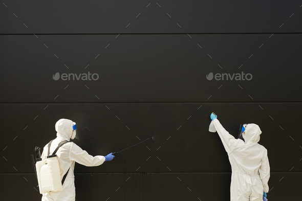 Worker Disinfecting Black Wall Background - Stock Photo - Images
