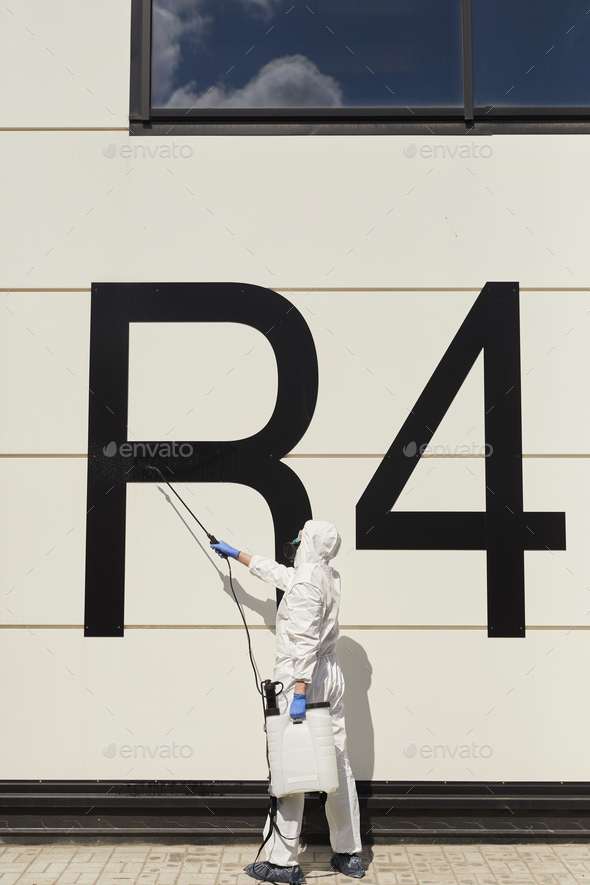 Worker Disinfecting Hangar - Stock Photo - Images