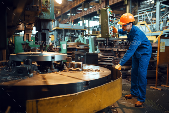 Turner works on large lathe, factory - Stock Photo - Images