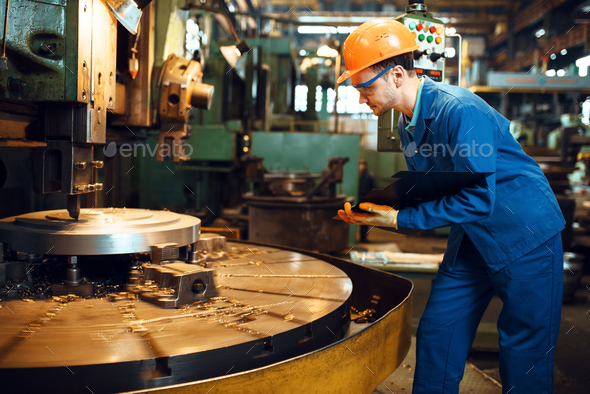 Turner stanging at the automated lathe, factory - Stock Photo - Images