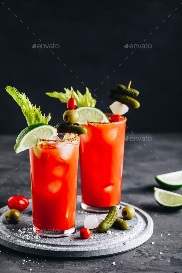 Bloody Mary Cocktail in glasses with garnishes. - Stock Photo - Images
