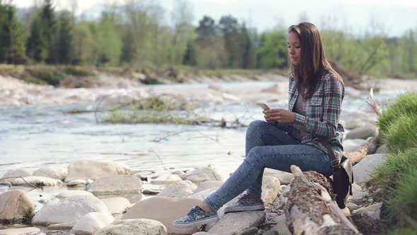 Girl texting with her mobile phone and relaxing