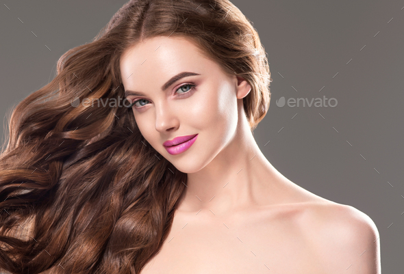 Beautiful woman long brunette beauty hair and natural makeup close up portrait