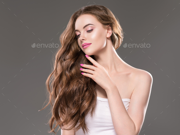 Beautiful woman long brunette beauty hair and natural makeup close up portrait