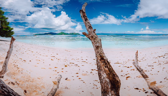 Impressive cloudscape above tropical island Praslin. Panorama of white sand paradise beach of anse - Stock Photo - Images