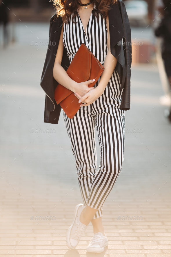 Stylish spring look with striped overalls and leather jacket - Stock Photo - Images