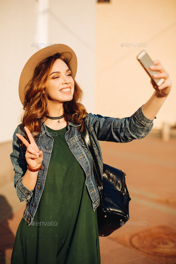 Brunette making duck face and taking self portrait - Stock Photo - Images