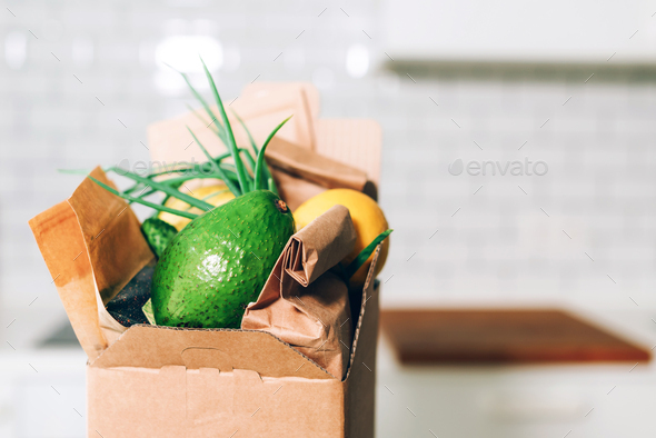 Donation box with healthy food on white kitchen background. Copy space. Food delivery service during - Stock Photo - Images