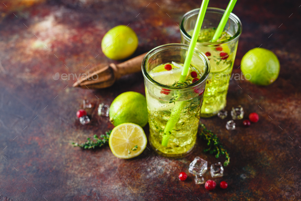 Lime Lemonade with thyme, cranberry and ice. - Stock Photo - Images