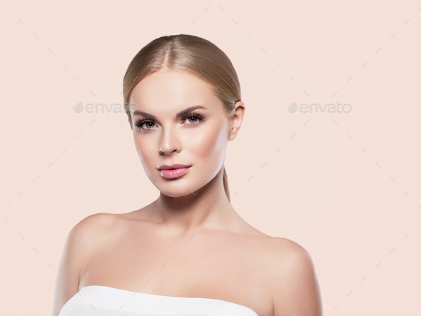Beauty woman healthy skin natural makeup close up face. Beige background.