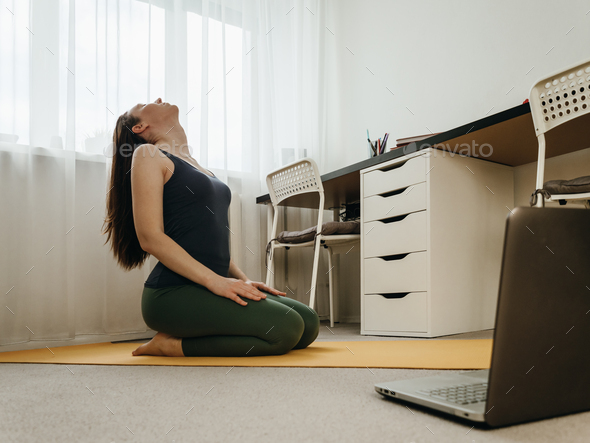 Yoga at home near laptop