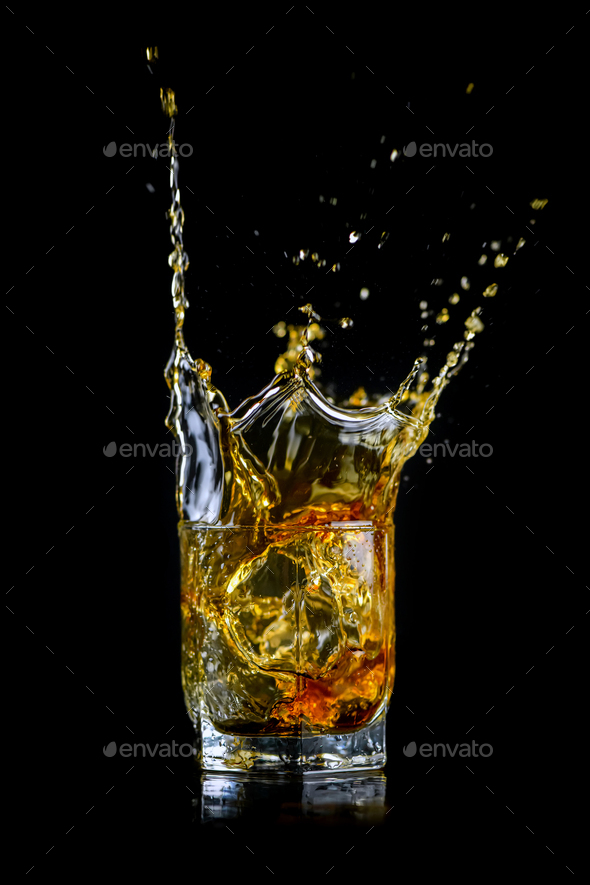 Whiskey Splash With Ice Cubes Isolated On White Stock Photo