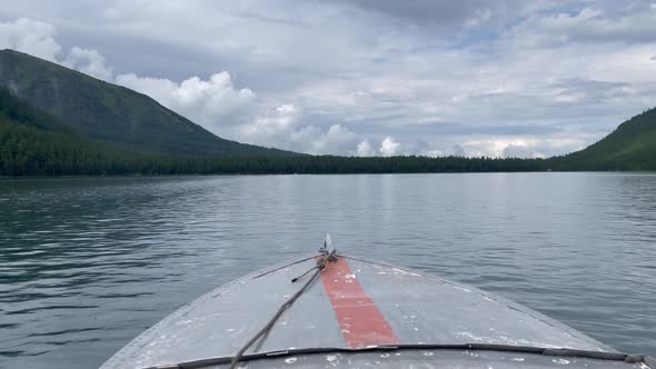 Motorboat on Multin lakes in middle of mountains in Altai