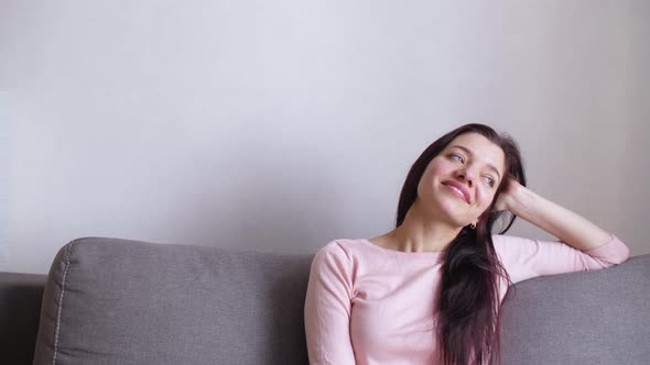 Girl at Home on the Background of a Light Wall alt