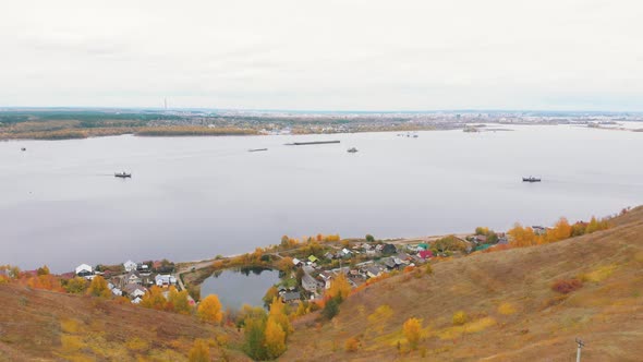 A Landscape of a Village on the Coast of the River alt