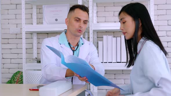 Doctor in Professional Uniform Examining Patient at Hospital alt