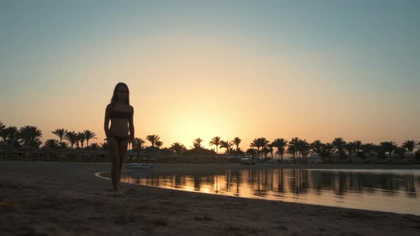 Beautiful Teenager Girl Showing Somersault at Early Morning Sea Beach. alt