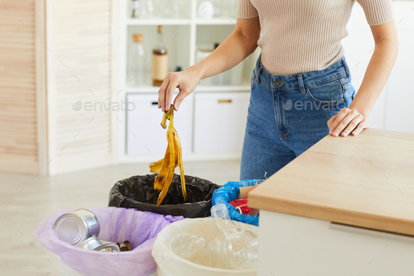 Woman sorting waste at home