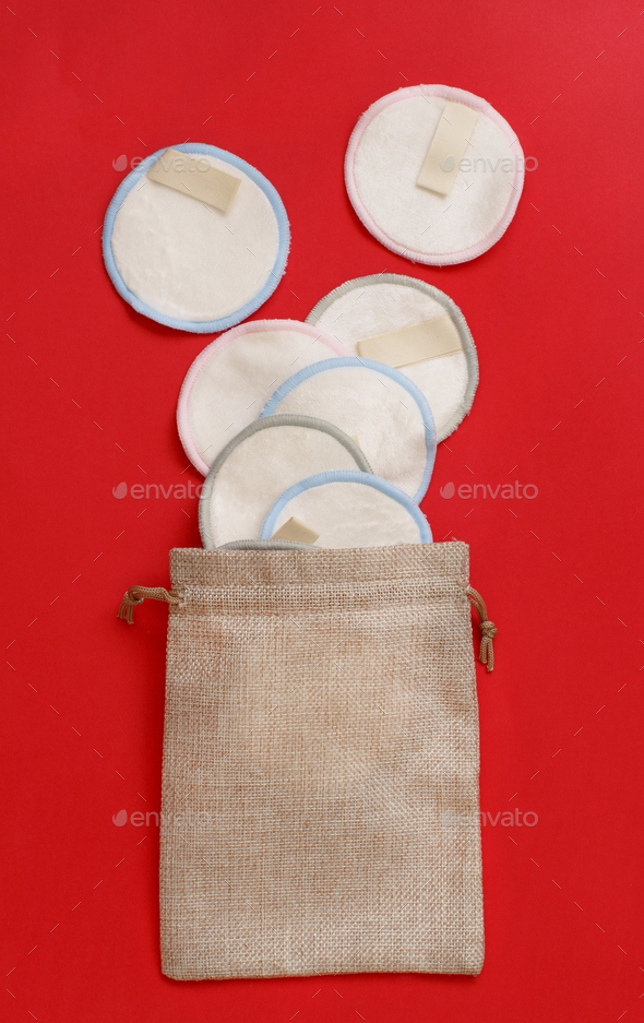 Eco friendly reusable make-up remover pads on red background