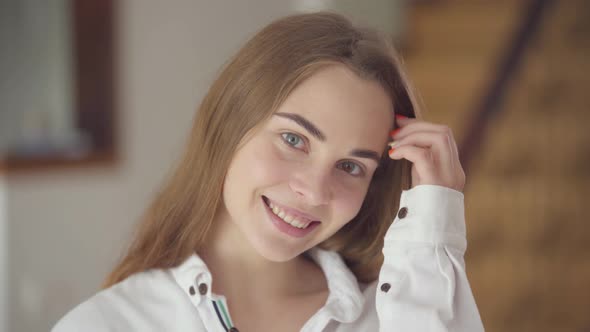 Portrait of Confident Carefree Beautiful Young Smiling Woman with Different Colored Eyes Looking alt