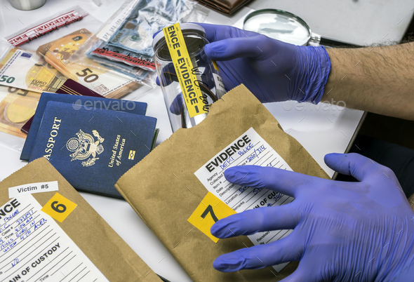 Expert police officer examining American passport of a evidence bag