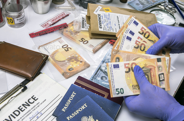 American passport and money of a evidence bag in laboratory of criminology, conceptual image