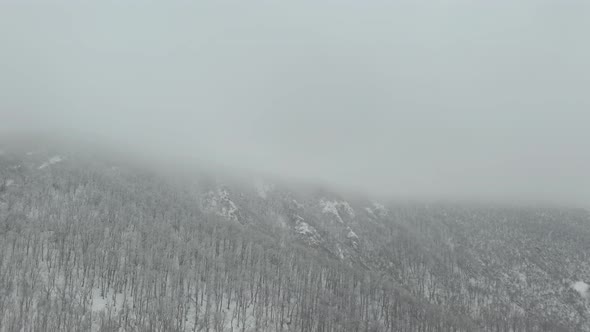 Veliki Krs mountain ridge in heavy fog 4K aerial video