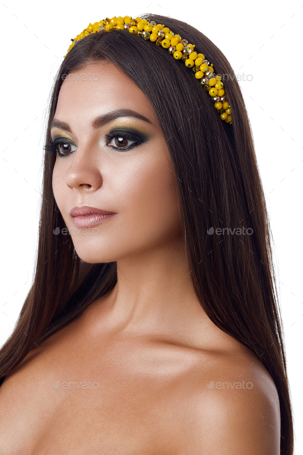 Portrait of beautiful brunette woman with big earring and shinny yellow accessories in hair. Perfect - Stock Photo - Images