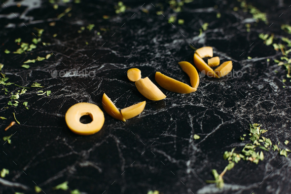 little-letters-of-fruits-at-black-background-in-word-olive-stock-photo-by-studiolucky