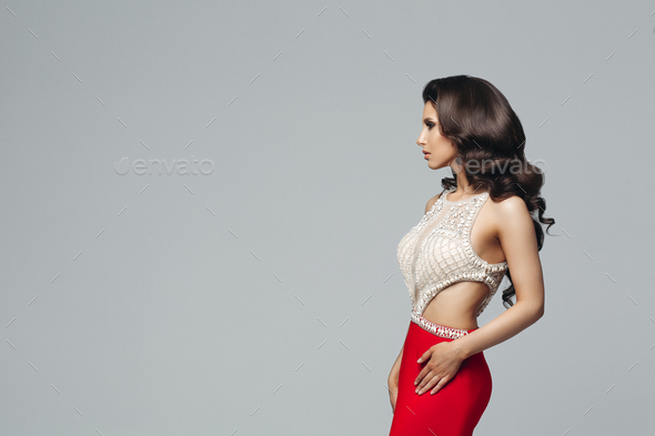 Gorgeous brunette posing in shiny dress with diamonds - Stock Photo - Images