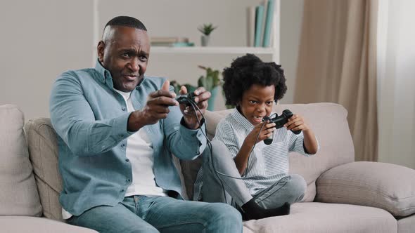 Happy African American Family Dad and Daughter Have Fun Together Father Playing Video Game on alt
