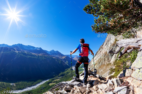 Hiker takes a rest observing a mountain panorama. Mont Blanc - Stock Photo - Images