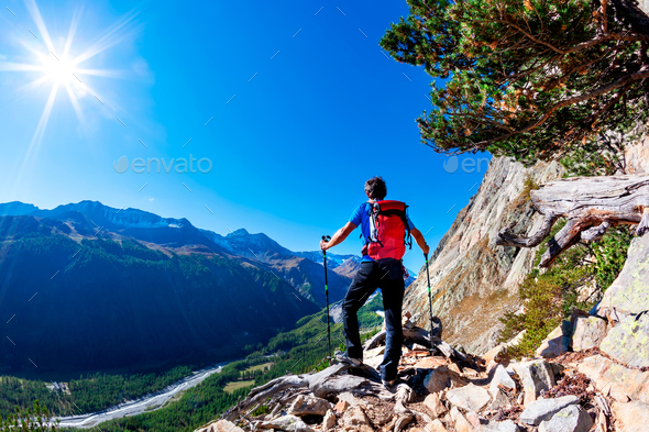 Hiker takes a rest observing a mountain panorama. Mont Blanc Massif, Italian Alps, - Stock Photo - Images